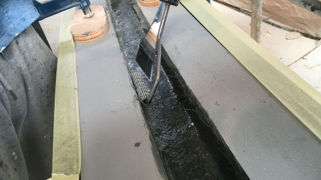 close up hand rolling fiberglass material