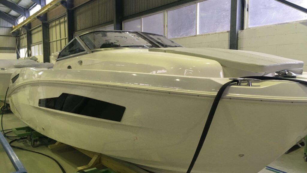Fiberglass boat gunnel replacement - a powerboat inside a company for repair
