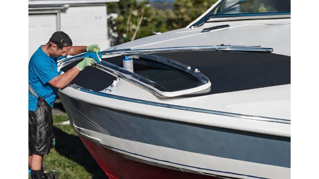 someone cleaning metal parts of a boat