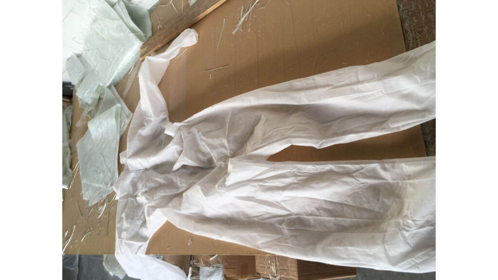 a white uniform to protect clothes from fiberglass material
